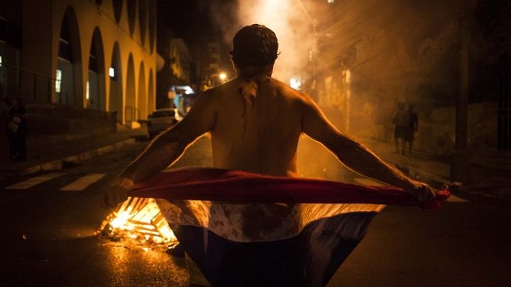 Why did one of the happiest countries in the world burn down its Congress?